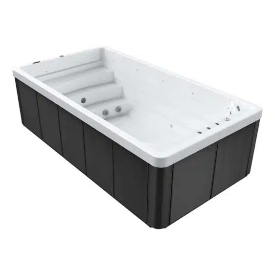 Spa de nage D460 avec panneaux extérieurs sombres, intérieur blanc, marches intégrées et jets latéraux, pompe à chaleur incluse. Ce spa moderne de forme rectangulaire est présenté vide.
