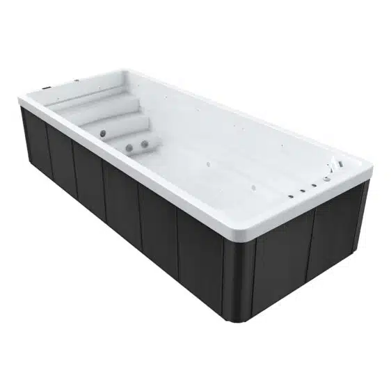 Spa de nage rectangulaire avec intérieur blanc, marches intégrées et multiples jets d'eau. Les panneaux extérieurs foncés confèrent au Spa de nage D600N un look moderne et épuré.